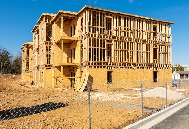 a close-up of temporary chain link fences enclosing a construction site, signaling progress in the project's development in Byhalia, MS